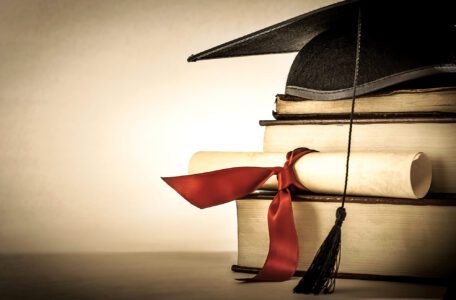 article image - A,Mortarboard,And,Graduation,Scroll,,Tied,With,Red,Ribbon,,On